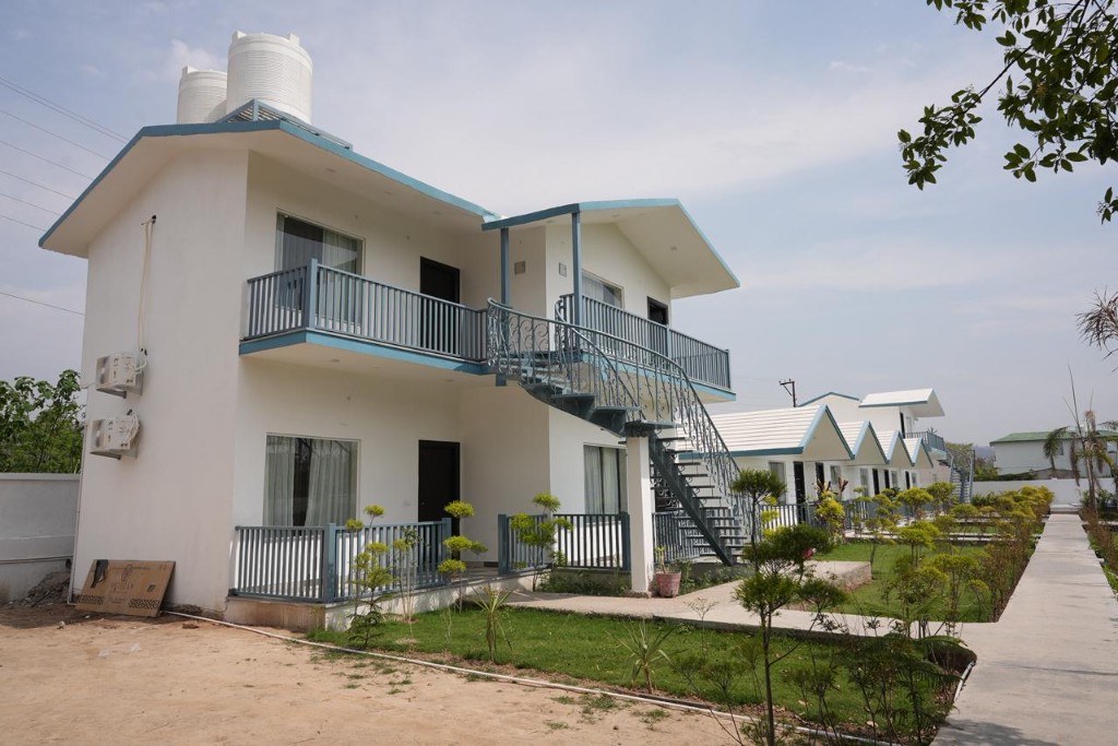 Resort dining hall with wood tables and upholstered seating