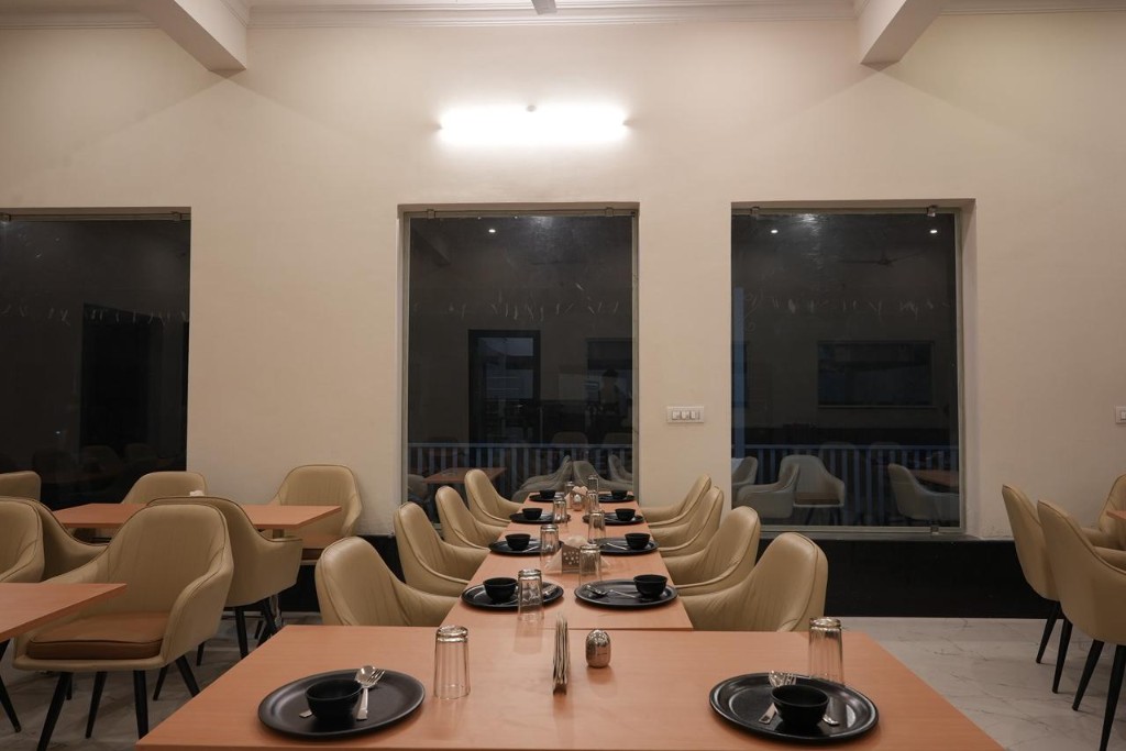 Modern guest room with dark wood furniture and ceiling fan