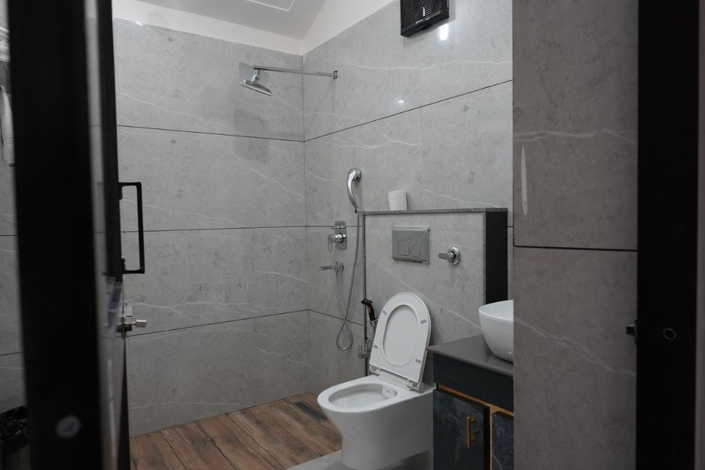 Bright bedroom with navy accents and sheer curtains