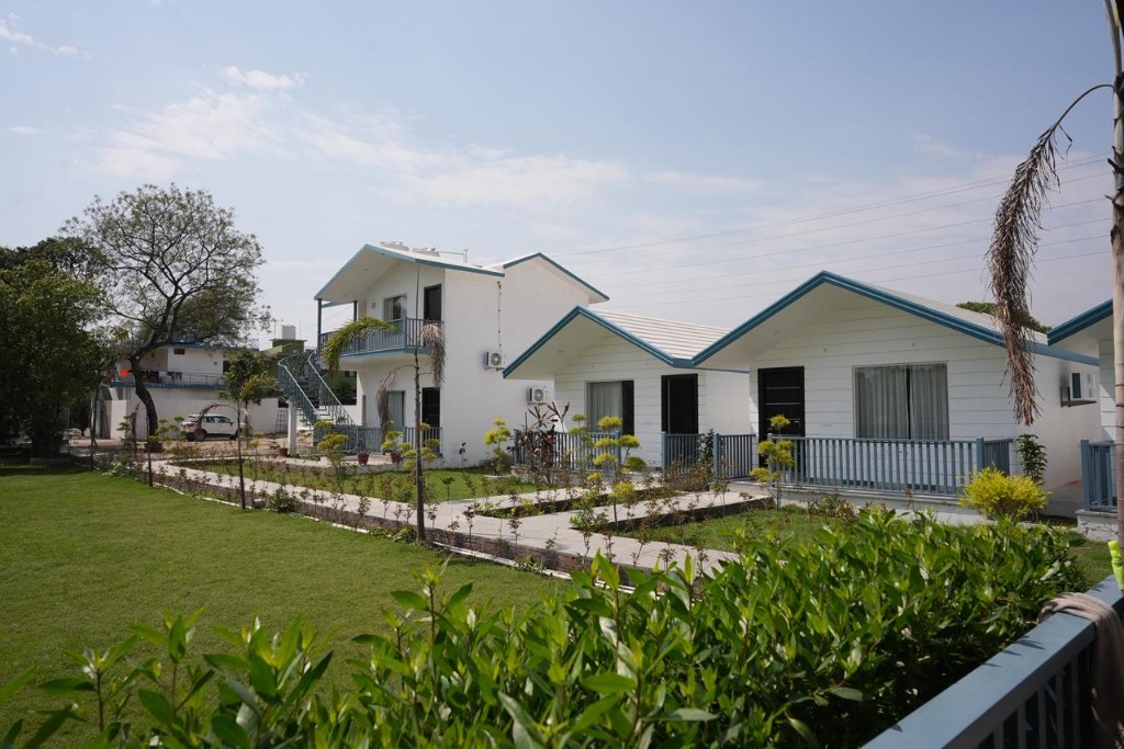 Resort grounds with two-storey villa, lawn, and walkways