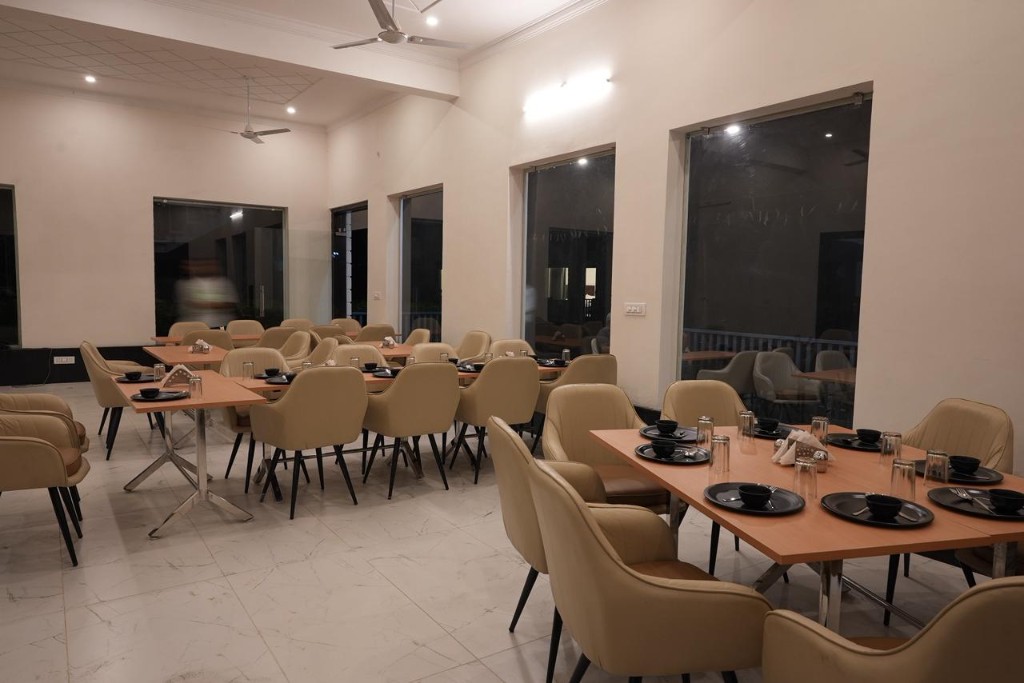 Single-storey cottage entrance with blue railing and green lawn