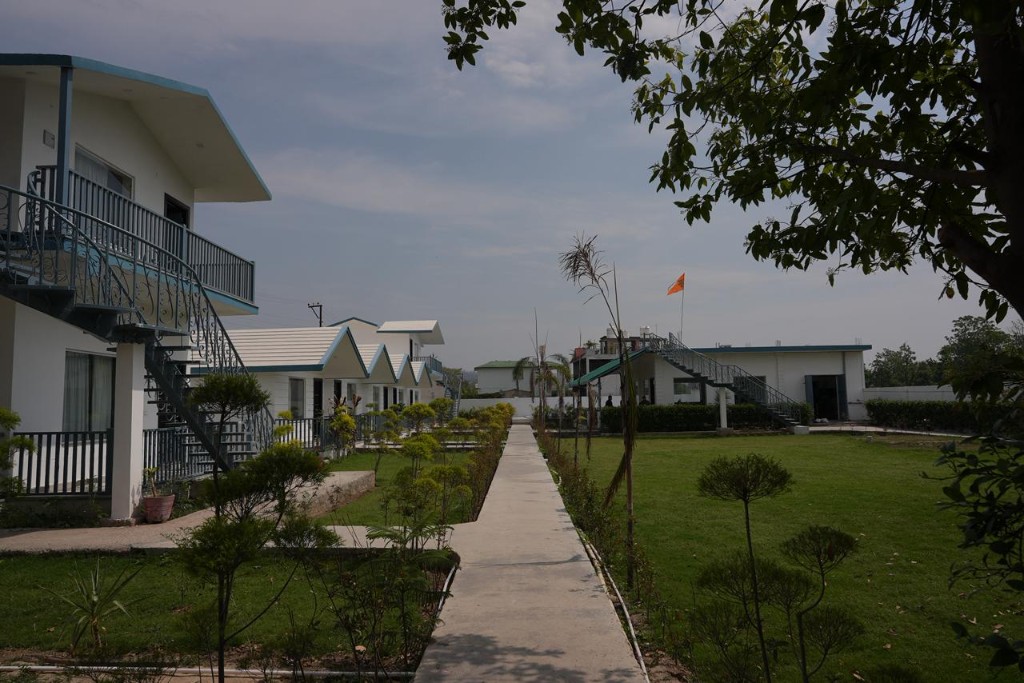 Resort cottages along walkway with young trees and shrubs